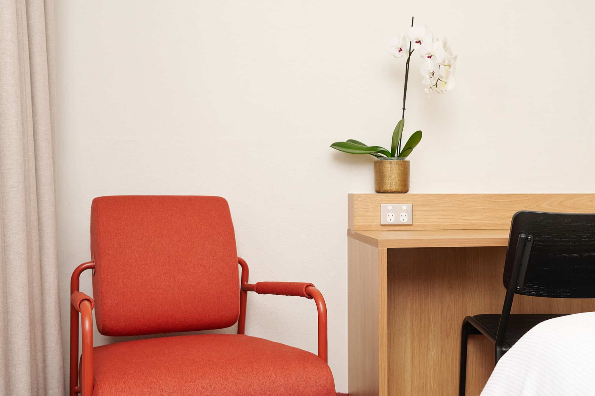Red chair and working desk in upper house queen room